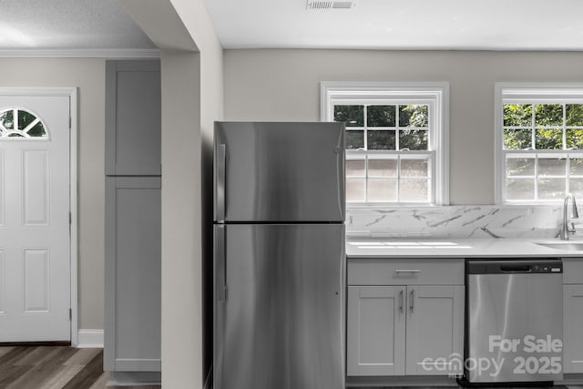 509 8th Avenue Ext, Cramerton, NC 28032 - kitchen featuring stainless steel appliances, gray cabinets, wood finished floors, decorative backsplash, and ornamental molding