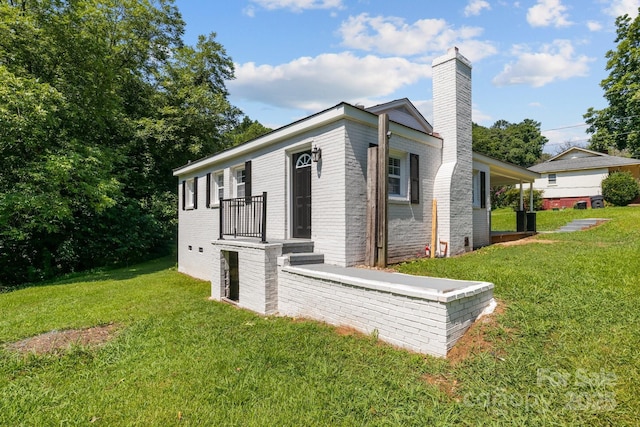 509 8th Avenue Ext, Cramerton, NC 28032 - view of side of property with a chimney, a yard, and brick siding