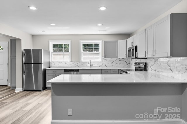 509 8th Avenue Ext, Cramerton, NC 28032 - kitchen featuring stainless steel appliances, light countertops, recessed lighting, light wood-style flooring, and gray cabinets
