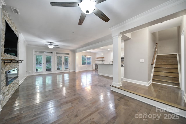 329 Wave Crest Dr, Tega Cay, SC 29708 - unfurnished living room featuring a fireplace, a ceiling fan, hardwood / wood-style floors, stairs, and crown molding