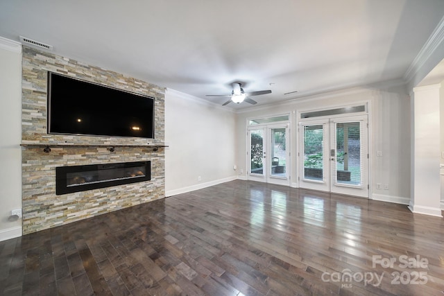 329 Wave Crest Dr, Tega Cay, SC 29708 - unfurnished living room featuring ceiling fan, wood finished floors, crown molding, and a stone fireplace