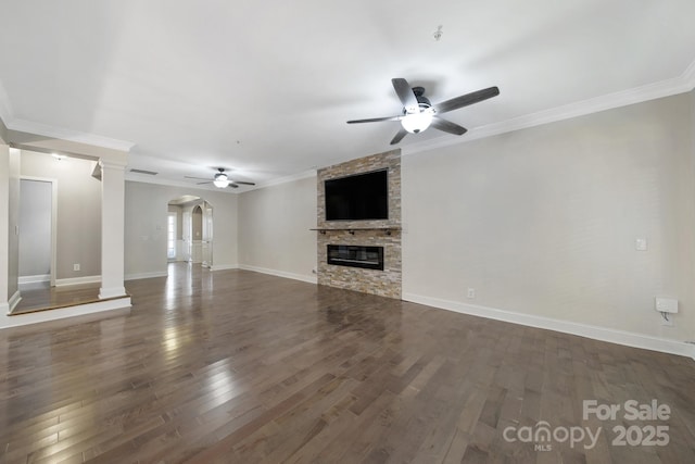 329 Wave Crest Dr, Tega Cay, SC 29708 - unfurnished living room with a ceiling fan, arched walkways, a stone fireplace, dark wood finished floors, and ornamental molding
