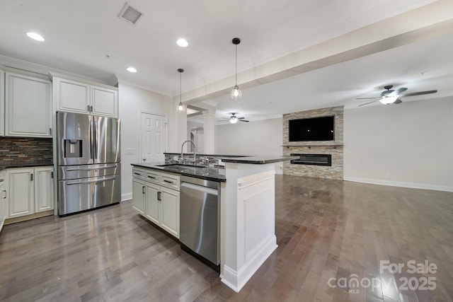 329 Wave Crest Dr, Tega Cay, SC 29708 - kitchen with appliances with stainless steel finishes, ceiling fan, dark countertops, open floor plan, and dark wood finished floors