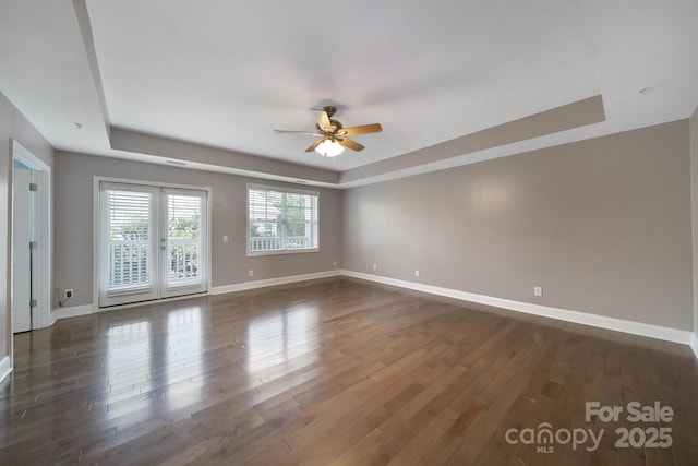 329 Wave Crest Dr, Tega Cay, SC 29708 - empty room with a tray ceiling, a ceiling fan, and dark wood-style flooring