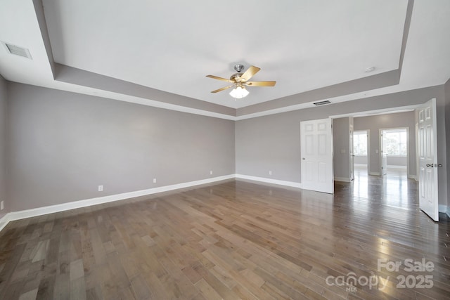 329 Wave Crest Dr, Tega Cay, SC 29708 - spare room with a tray ceiling, ceiling fan, and wood finished floors