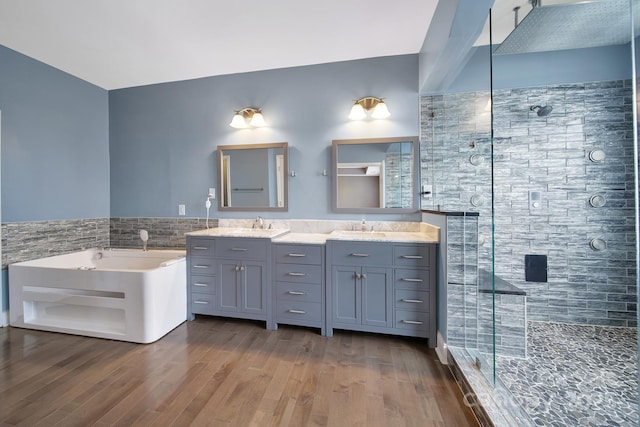 329 Wave Crest Dr, Tega Cay, SC 29708 - bathroom featuring a stall shower, double vanity, wood finished floors, a bath, and tile walls