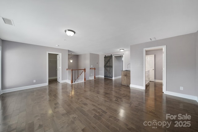 329 Wave Crest Dr, Tega Cay, SC 29708 - unfurnished room featuring a barn door and dark wood-style floors