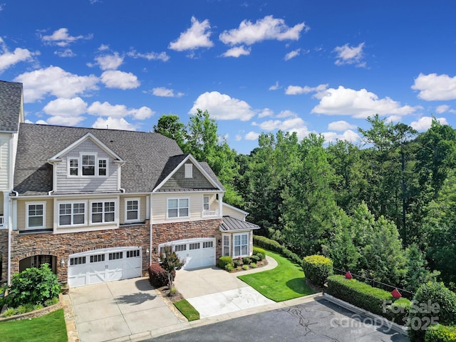 329 Wave Crest Dr, Tega Cay, SC 29708 - view of front facade featuring stone siding, driveway, an attached garage, and roof with shingles