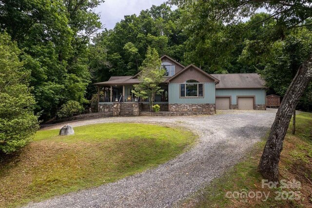 486 Center Dr Unit 7B, Bryson City, NC 28713 - view of front of home with a porch, curved driveway, a front yard, and stone siding