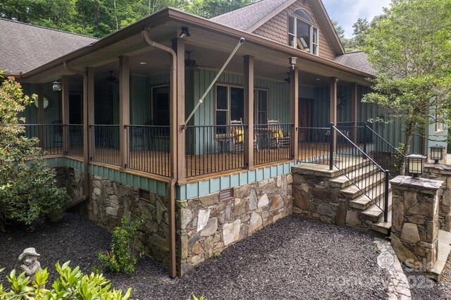 486 Center Dr Unit 7B, Bryson City, NC 28713 - view of side of property with roof with shingles, stairway, and stone siding