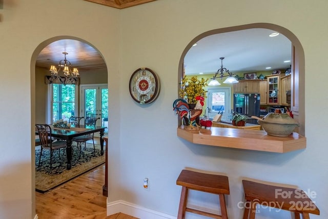 486 Center Dr Unit 7B, Bryson City, NC 28713 - hallway featuring arched walkways, wood finished floors, plenty of natural light, a chandelier, and recessed lighting