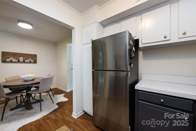2620 Park Rd Unit F, Charlotte, NC 28209 - kitchen featuring freestanding refrigerator, white cabinetry, crown molding, dark wood-type flooring, and light countertops