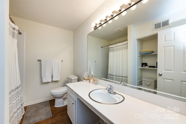 2620 Park Rd Unit F, Charlotte, NC 28209 - bathroom with wood finished floors, vanity, and a shower with shower curtain