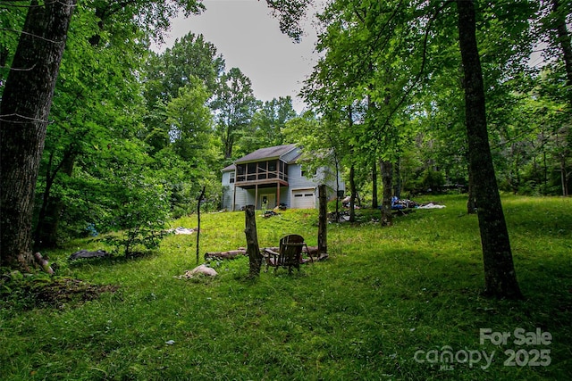 164 Horseplay Ln, Lake Toxaway, NC 28747 - view of green lawn featuring an attached garage, a wooden deck, and a view of trees
