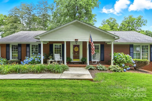 701 4th Ave NE, Conover, NC 28613 - ranch-style house featuring brick siding, covered porch, a front lawn, and roof with shingles