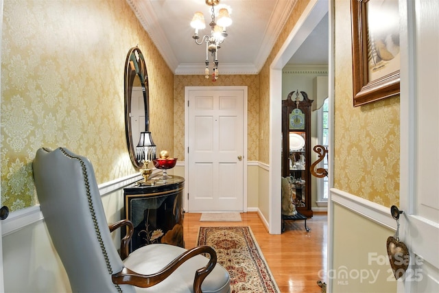 701 4th Ave NE, Conover, NC 28613 - foyer featuring wallpapered walls, light wood-type flooring, wainscoting, a chandelier, and ornamental molding