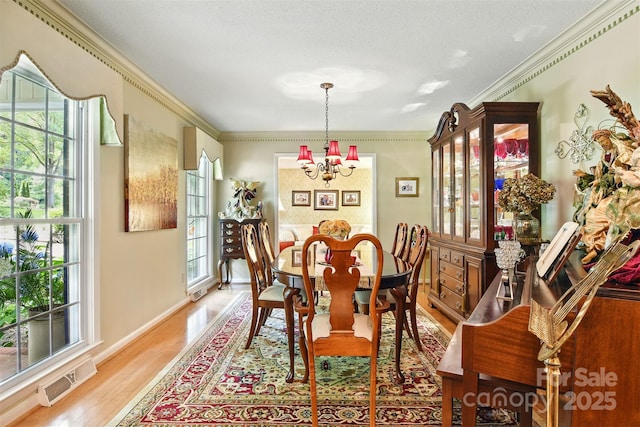 701 4th Ave NE, Conover, NC 28613 - dining area featuring a chandelier, light wood finished floors, and ornamental molding