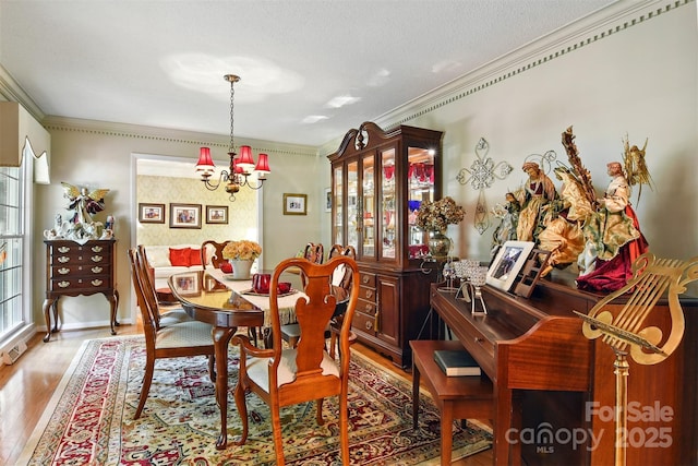 701 4th Ave NE, Conover, NC 28613 - dining room with light wood-type flooring, ornamental molding, and a chandelier