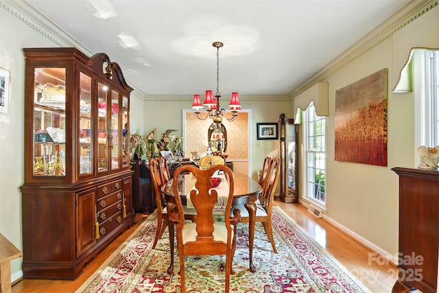 701 4th Ave NE, Conover, NC 28613 - dining room featuring light wood-type flooring, a chandelier, and ornamental molding