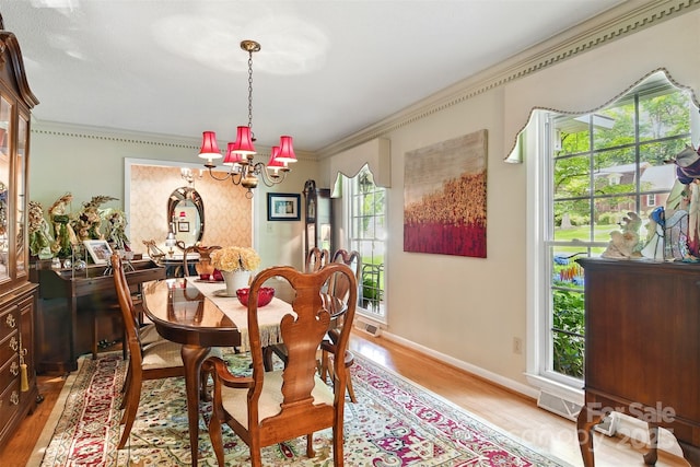 701 4th Ave NE, Conover, NC 28613 - dining room with a chandelier, ornamental molding, and light wood-type flooring