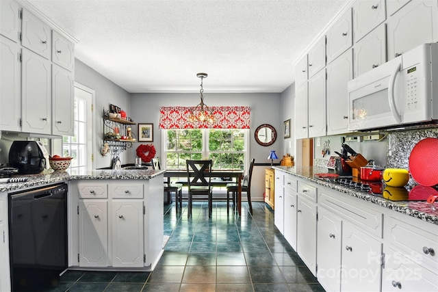 701 4th Ave NE, Conover, NC 28613 - kitchen with black appliances, healthy amount of natural light, white cabinets, dark tile patterned flooring, and a textured ceiling