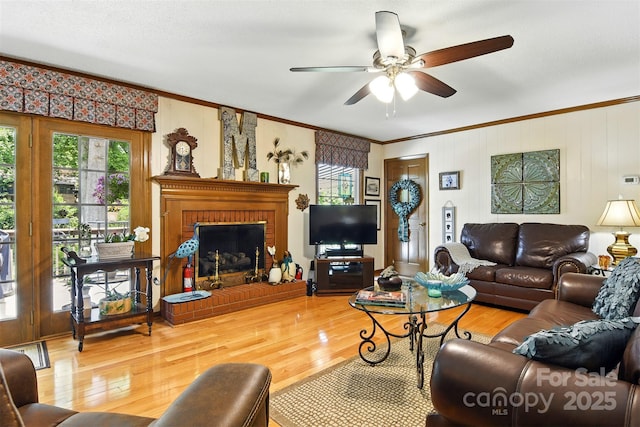 701 4th Ave NE, Conover, NC 28613 - living room with ornamental molding, plenty of natural light, wood finished floors, a ceiling fan, and a fireplace