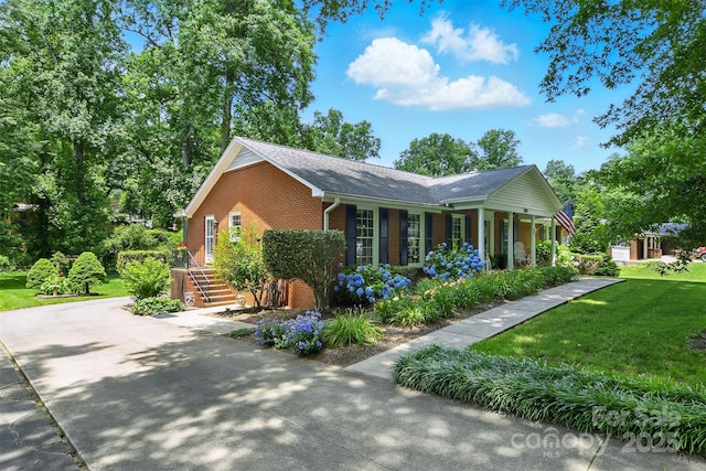 701 4th Ave NE, Conover, NC 28613 - view of home's exterior with brick siding, a yard, roof with shingles, and concrete driveway