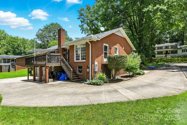 701 4th Ave NE, Conover, NC 28613 - view of home's exterior featuring a chimney, brick siding, a deck, stairs, and a patio area