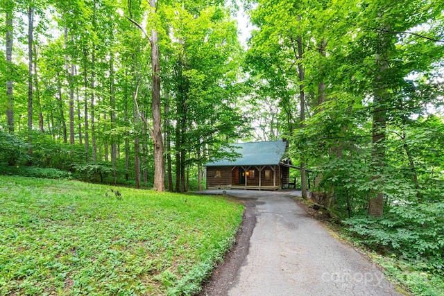 25 Trillium Trce, Maggie Valley, NC 28751 - view of yard with driveway, a view of trees, and covered porch