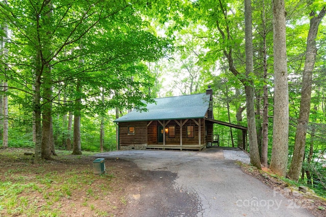 25 Trillium Trce, Maggie Valley, NC 28751 - view of front of property featuring driveway, a porch, and a chimney