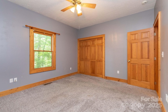 25 Trillium Trce, Maggie Valley, NC 28751 - unfurnished bedroom featuring carpet flooring, a closet, a ceiling fan, and a textured ceiling