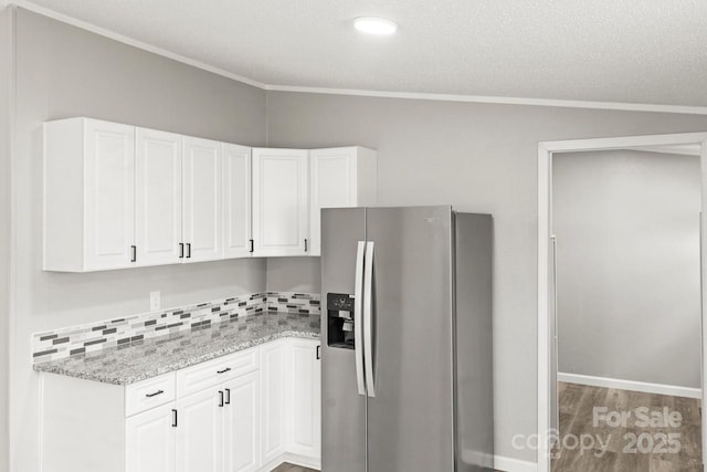 1133 Lynn Ln, Catawba, NC 28609 - kitchen featuring stainless steel refrigerator with ice dispenser, crown molding, white cabinetry, backsplash, and light stone counters