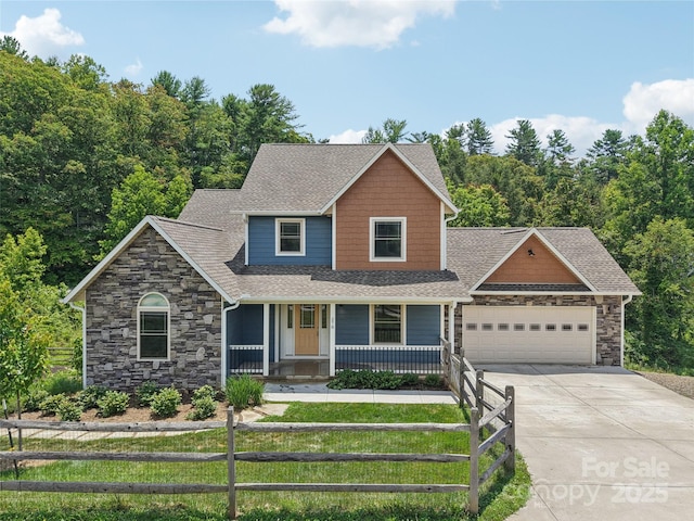 278 Ollie Weaver Rd, Weaverville, NC 28787 - view of front of home featuring stone siding, an attached garage, driveway, covered porch, and a shingled roof