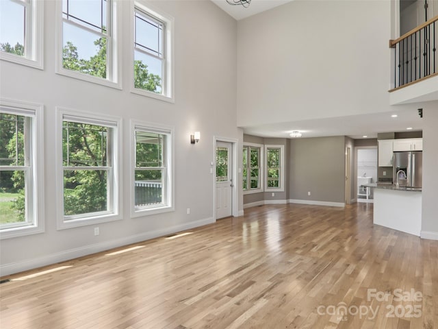 278 Ollie Weaver Rd, Weaverville, NC 28787 - unfurnished living room featuring a towering ceiling and light wood finished floors