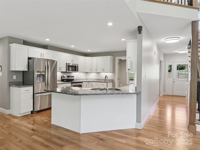 278 Ollie Weaver Rd, Weaverville, NC 28787 - kitchen with appliances with stainless steel finishes, light wood-style floors, dark stone counters, white cabinets, and recessed lighting