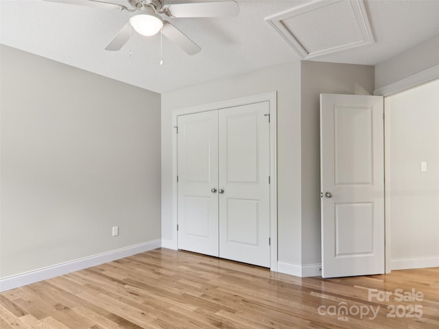 278 Ollie Weaver Rd, Weaverville, NC 28787 - unfurnished bedroom with light wood finished floors, a closet, attic access, and a ceiling fan