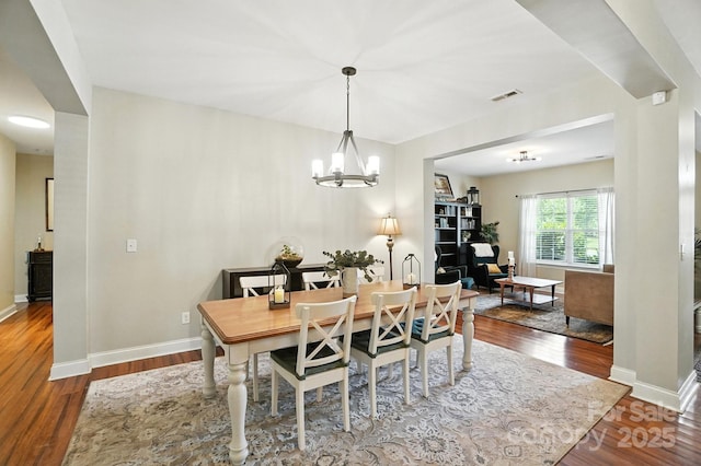1006 Spring Rose Ln, Matthews, NC 28104 - dining area featuring wood finished floors and a chandelier