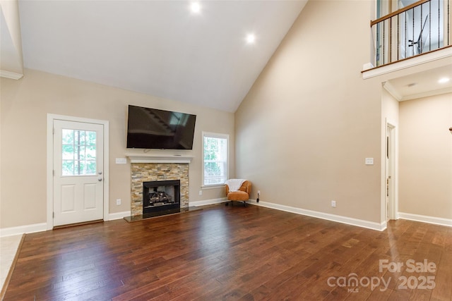 4203 Flint Dr, Lancaster, SC 29720 - unfurnished living room with high vaulted ceiling, hardwood / wood-style floors, and a stone fireplace