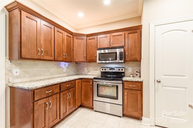 4203 Flint Dr, Lancaster, SC 29720 - kitchen featuring stainless steel appliances, crown molding, brown cabinetry, backsplash, and light tile patterned flooring