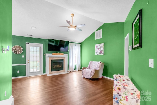 4614 Jacquelyne Dr, Indian Trail, NC 28079 - living area featuring a ceiling fan, vaulted ceiling, wood finished floors, and a fireplace with flush hearth