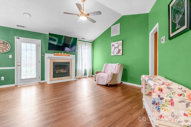 4614 Jacquelyne Dr, Indian Trail, NC 28079 - living area with a ceiling fan, vaulted ceiling, wood finished floors, and a fireplace with flush hearth