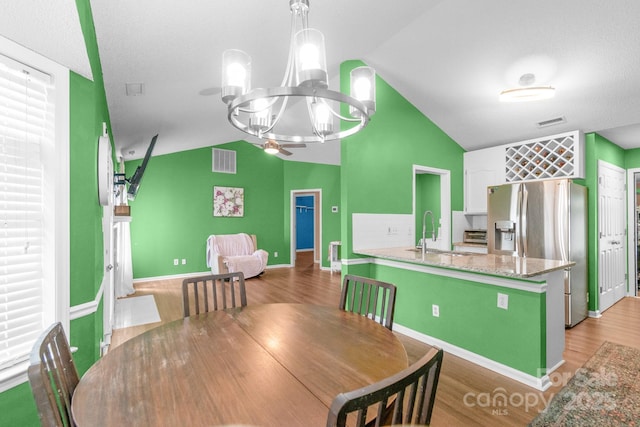 4614 Jacquelyne Dr, Indian Trail, NC 28079 - dining area featuring a chandelier, lofted ceiling, and light wood-style flooring
