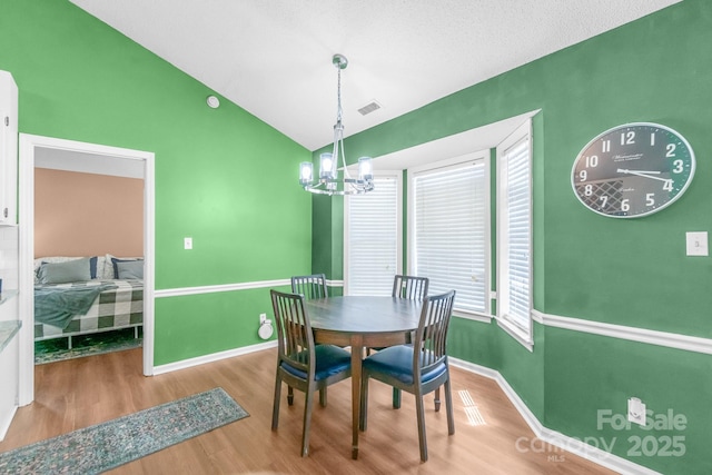 4614 Jacquelyne Dr, Indian Trail, NC 28079 - dining area with wood finished floors, lofted ceiling, and a chandelier
