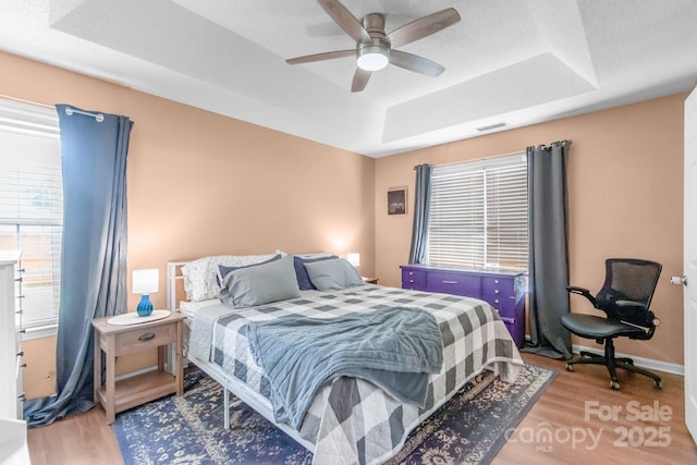 4614 Jacquelyne Dr, Indian Trail, NC 28079 - bedroom with a raised ceiling, light wood-style floors, and a ceiling fan
