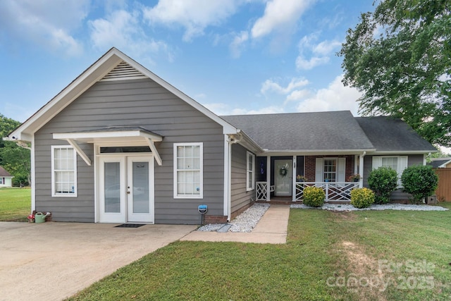 4614 Jacquelyne Dr, Indian Trail, NC 28079 - view of front facade with a porch, a front lawn, and a shingled roof