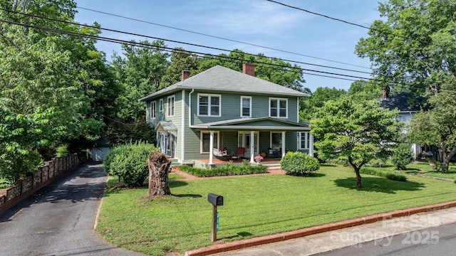 313 E Main St, Morganton, NC 28655 - american foursquare style home featuring a chimney, covered porch, and a front lawn