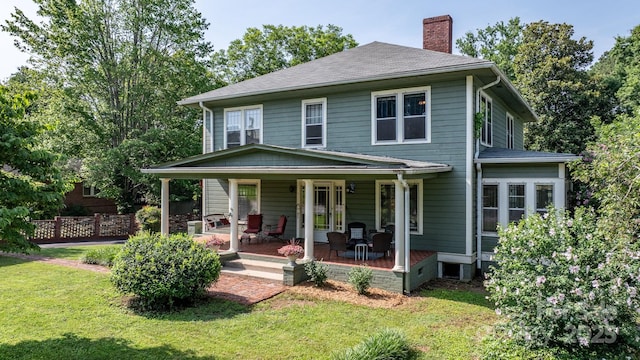 313 E Main St, Morganton, NC 28655 - view of front of home with a chimney, a front lawn, a shingled roof, and covered porch