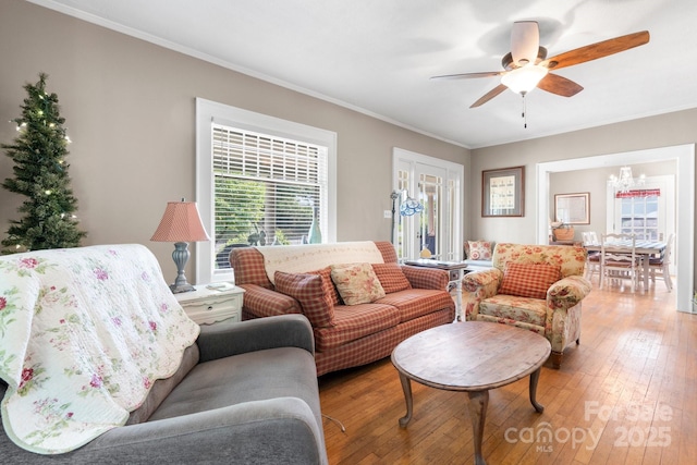 313 E Main St, Morganton, NC 28655 - living room featuring a chandelier, ceiling fan, ornamental molding, and light wood-type flooring