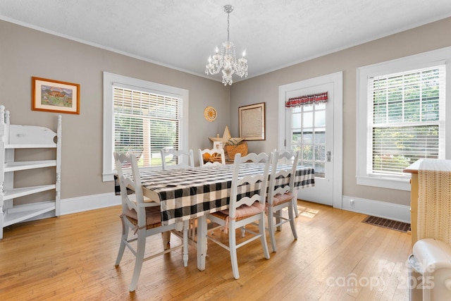 313 E Main St, Morganton, NC 28655 - dining space with a chandelier, light wood-type flooring, and crown molding