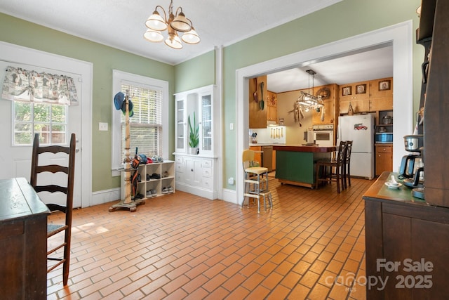 313 E Main St, Morganton, NC 28655 - dining space featuring a chandelier, brick patterned floors, and ornamental molding